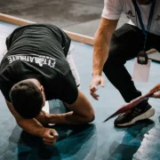 Coach guiding an athlete through a hard training set