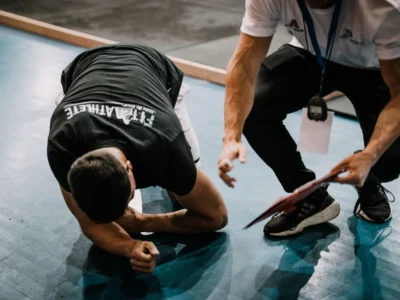 Coach guiding an athlete through a hard training set