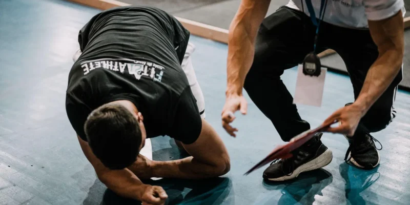 Coach guiding an athlete through a hard training set